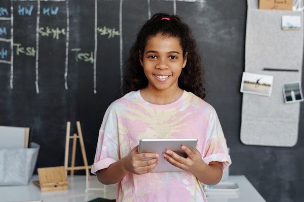 child holding ipad